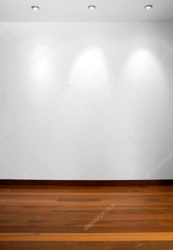 Empty white wall with 3 spot lights and wooden floor