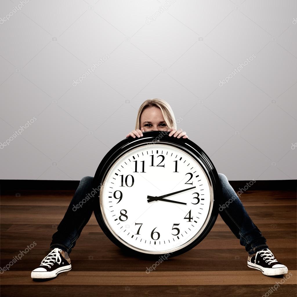Happy woman with a big clock: Time Concept