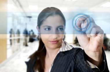 Busines woman at airport touching digital screen
