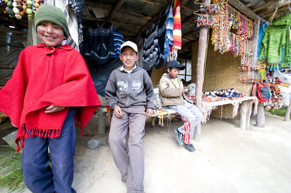 Young boys from Ecuador Andes at selling their handcrafts