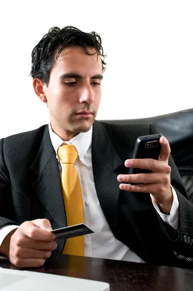 Business man at office paying with his credit cart trouhg his ce — Stock Photo, Image