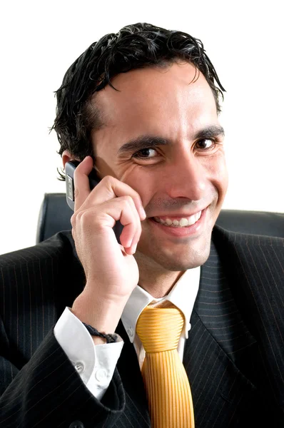 Young business man at office smiles at the phone — Stock Photo, Image