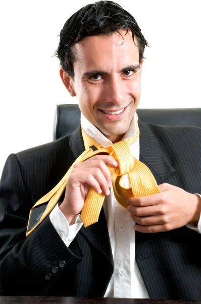 Relaxed smiling man at office making a tie knot — Stock Photo, Image