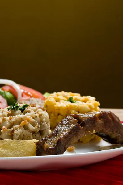 Эквадорская серия продуктов питания: свиные ребрышки с кукурузным салатом — стоковое фото