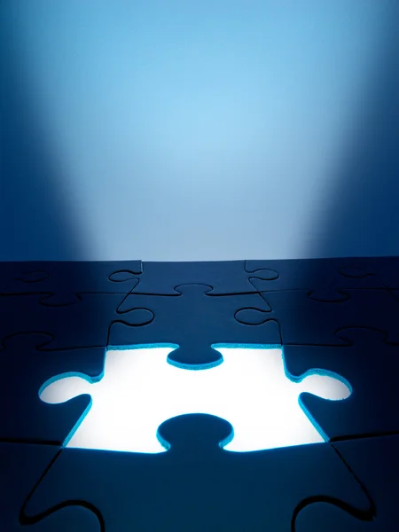 Light coming from the missing jigsaw puzzle: business. Human re — Stock Photo, Image