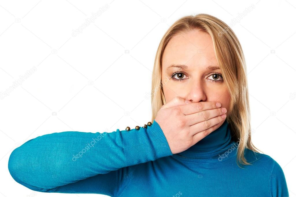 Woman covers her mouth with hand: Freedom of speech concept