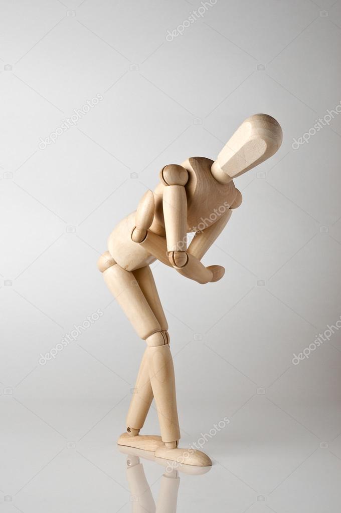wooden man with stomach ache