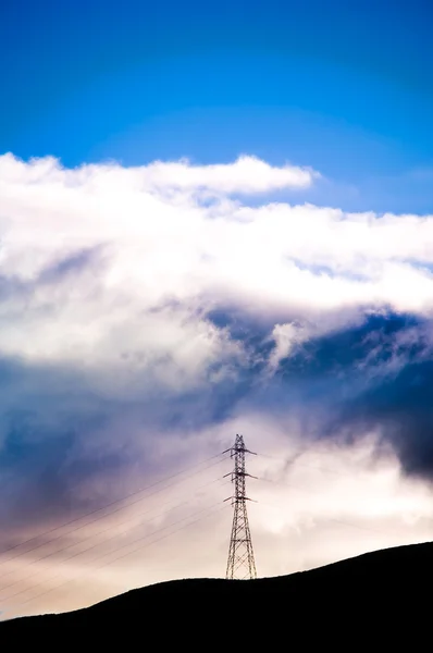 Electrical tower over the hills with dramatic skies — Stock Photo, Image