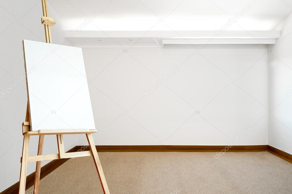 Empty white room with carpeted floor and an empty canvas on an easel