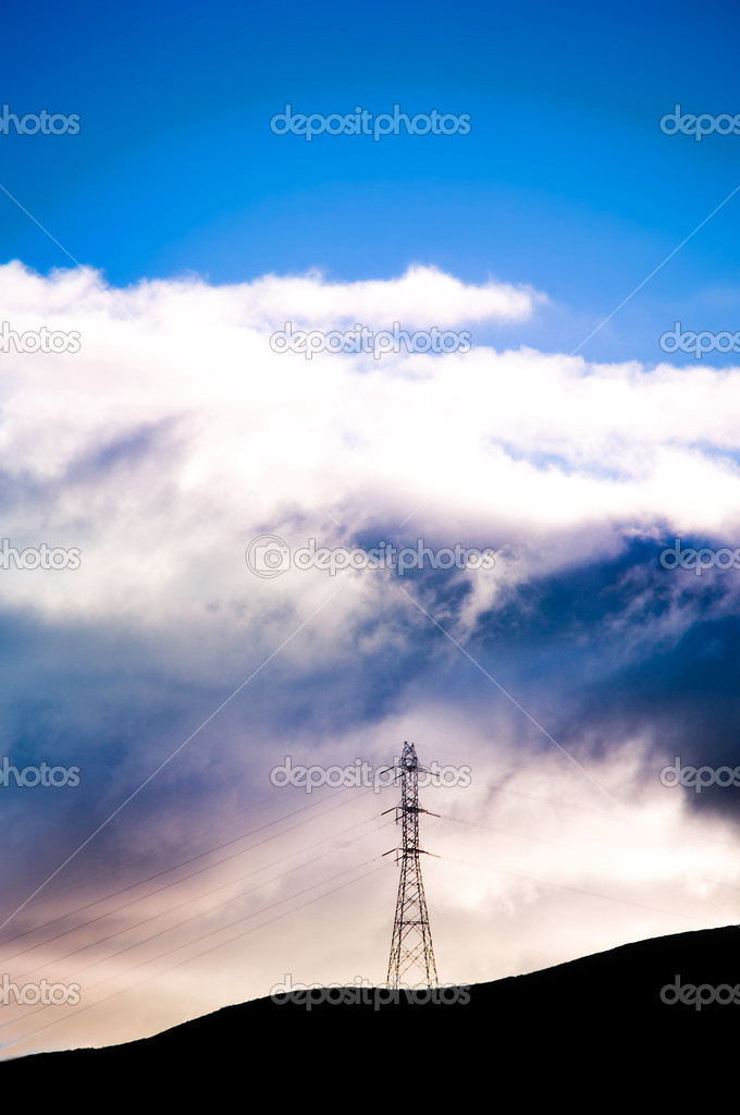 Electrical tower over the hills with dramatic skies