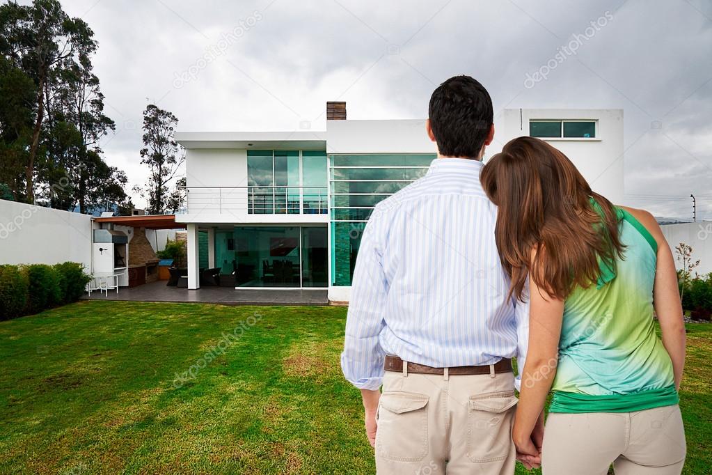 Young couple watching new big house