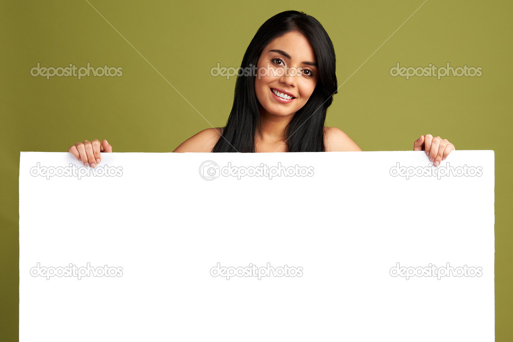 Young healthy woman holding white empty banner for copy space