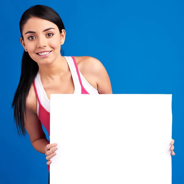 Young healthy woman holding white empty banner for copy space — Stock Photo, Image