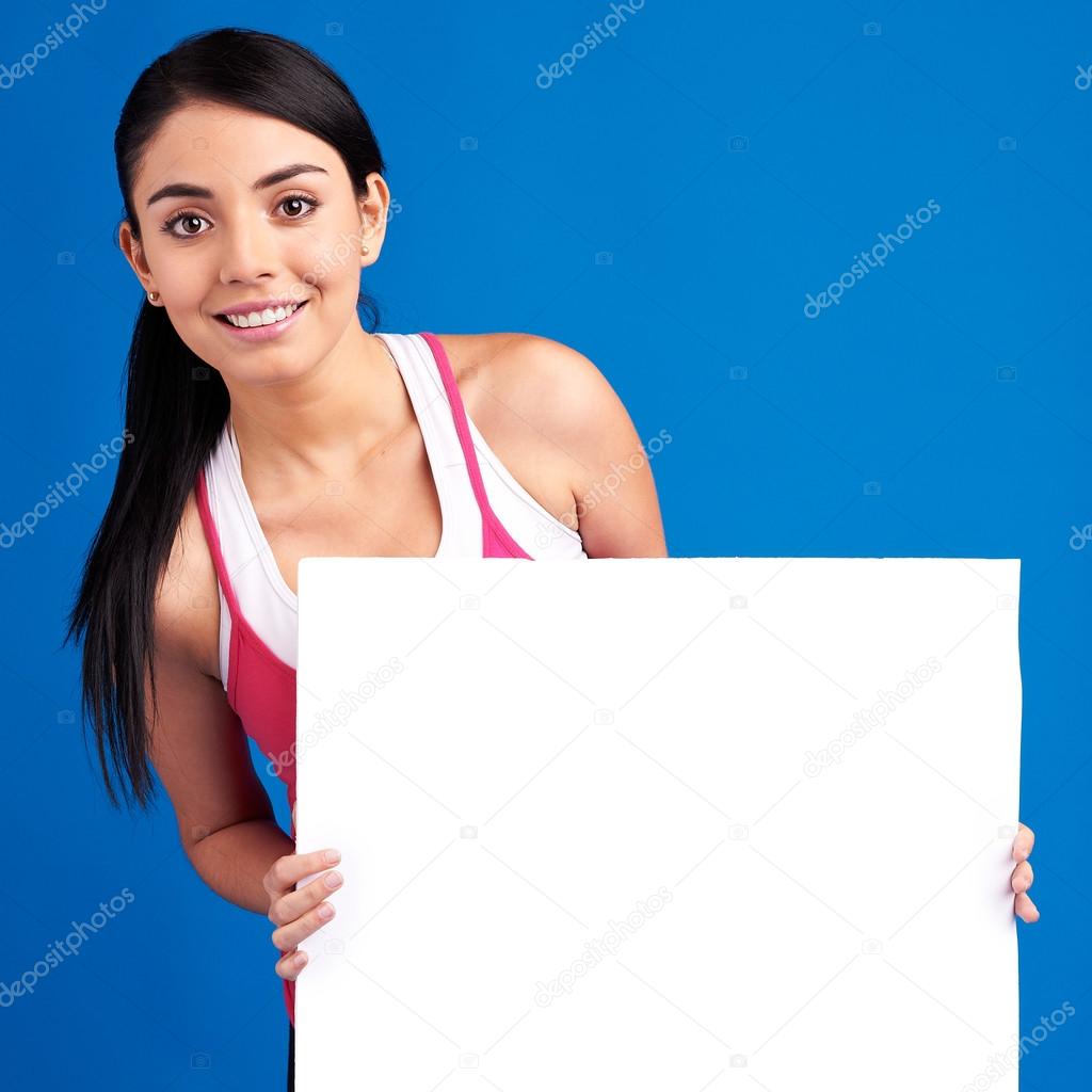 Young healthy woman holding white empty banner for copy space