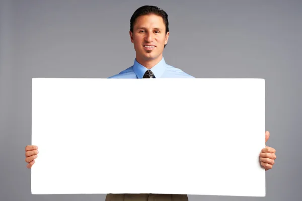 Advertising: Businessman holding big white empty paper — Stock Photo, Image