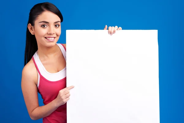 Young healthy woman holding white empty banner for copy space — Stock Photo, Image