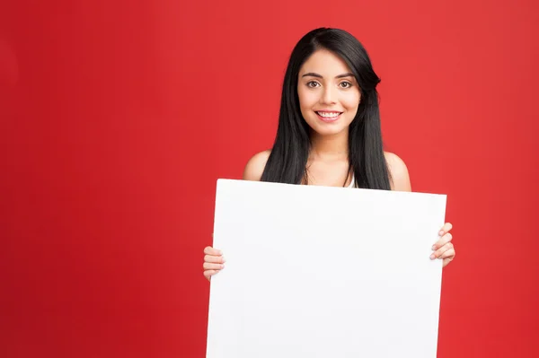 Fitness woman holding white empty banner — Stock Photo, Image