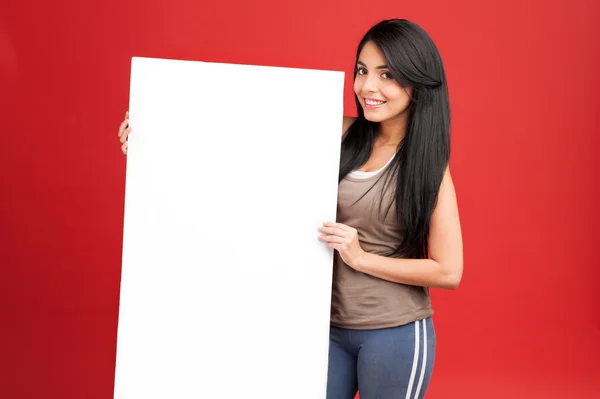 Fitness woman holding white empty banner — Stock Photo, Image