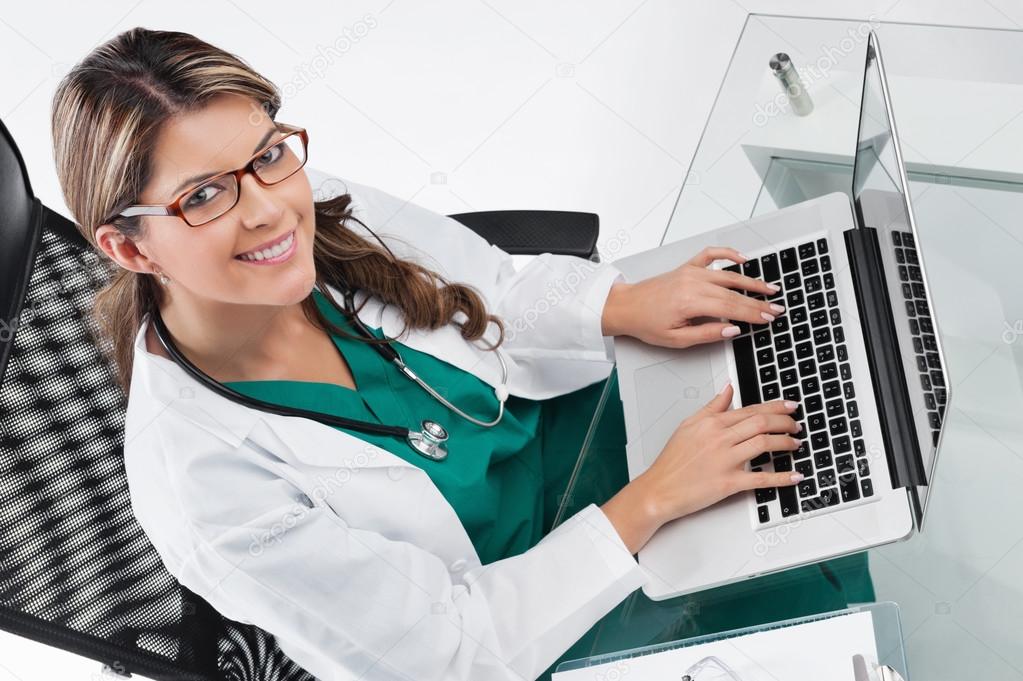 Woman doctor at desk with laptop