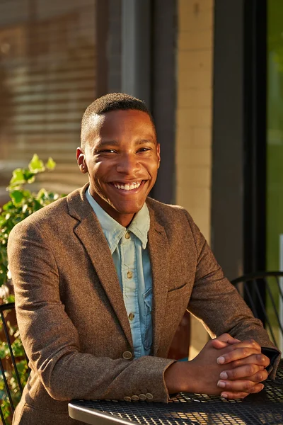 Young relaxed successful African - American business man in the — Stock Photo, Image