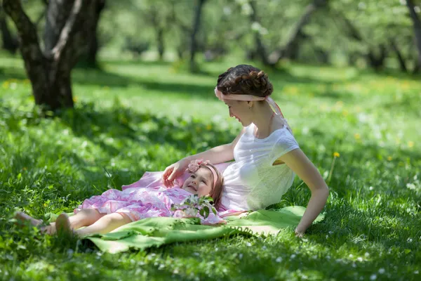 Girl and woman in the spring garden — Stock Photo, Image