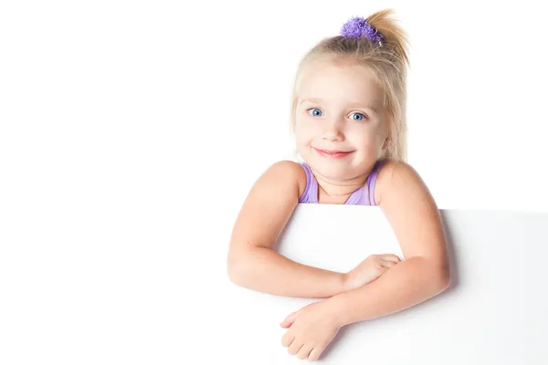 Surprised little girl looking over empty board — Stock Photo, Image