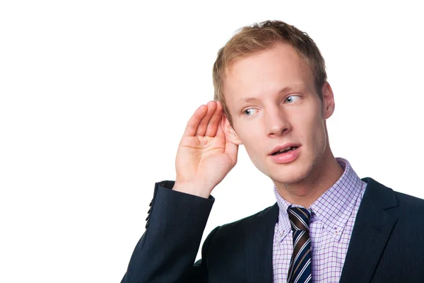 Hombre de negocios guapo escuchando algo — Foto de Stock