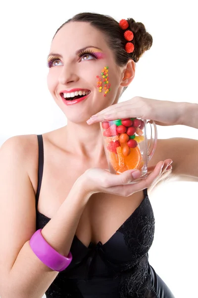 Happy girl with a glass and sweets — Stock Photo, Image
