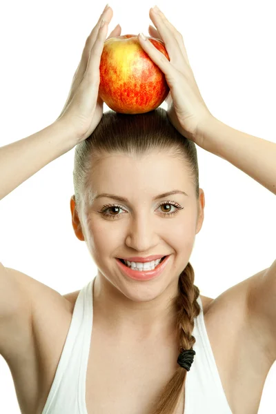 Beautiful young woman with red apple over her head — Stock Photo, Image