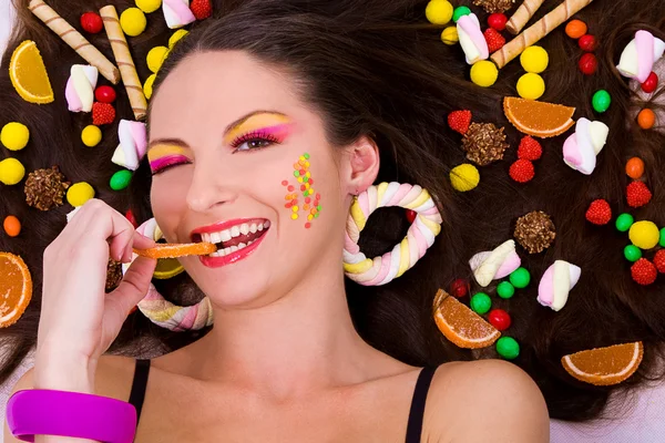 Beautiful girl with sweets and candies — Stock Photo, Image