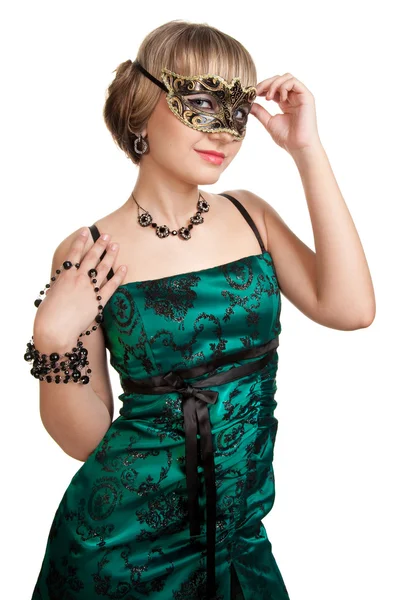 Beautiful girl in green evening dress with necklace and earrings in carnival mask hodling beads — Stock Photo, Image