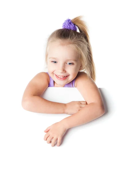 Smiling little girl looking over empty board isolated Stock Image