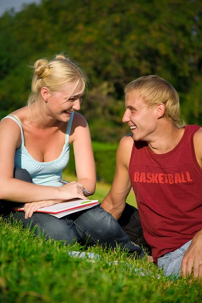 Blonde funny girl with blonde cute boy in the park laughting together — Stock Photo, Image
