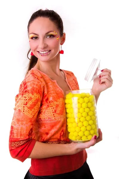 Smiling girl with jar of yellow sweets — Stock Photo, Image