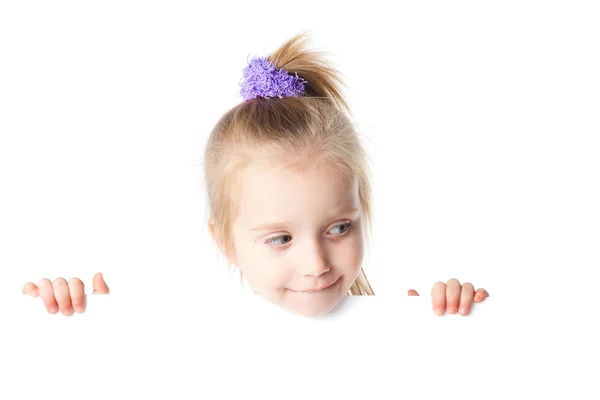 Little girl looking over empty board — Stock Photo, Image