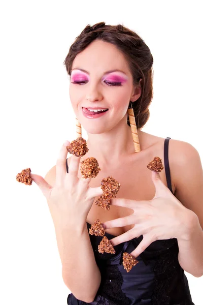 Beautiful girl with chocolate candies on her fingers — Stock Photo, Image