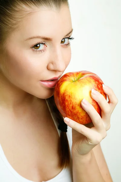 Beautiful young woman eating red apple Royalty Free Stock Images