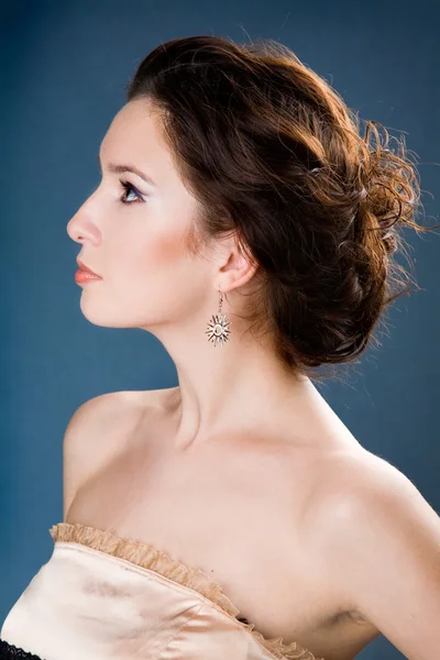 Beautiful young girl with silver earring — Stock Photo, Image