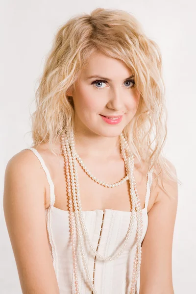 Beautiful blonde girl with beads — Stock Photo, Image