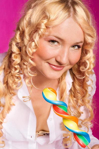 Young curly blonde girl holding big lollipop — Stock Photo, Image