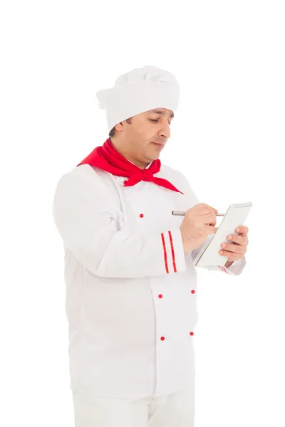 Cook man holding notebook and pen, thinking, whriting — Stock Photo, Image