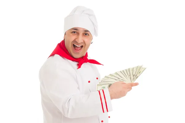 Cozinheiro homem segurando fã de dólares vestindo uniforme branco — Fotografia de Stock