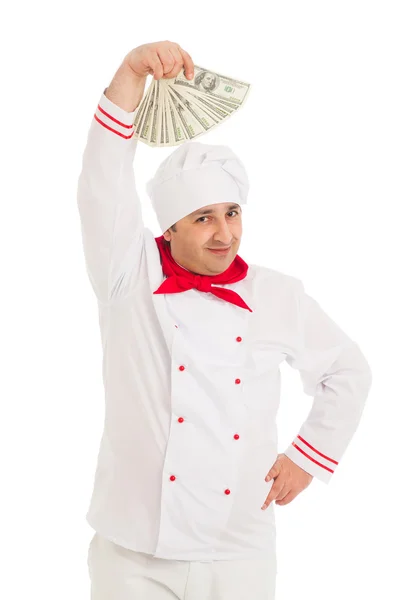 Cozinheiro homem segurando fã de dólares vestindo uniforme branco — Fotografia de Stock