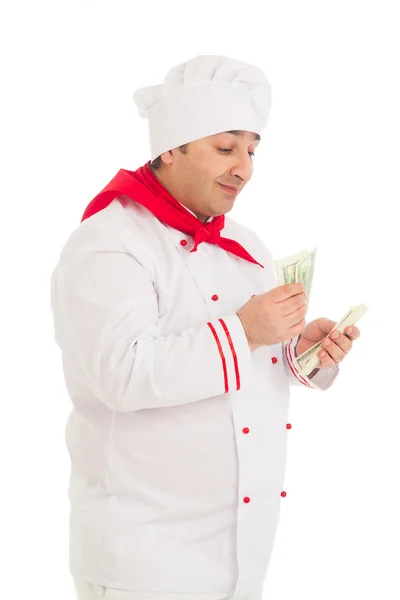 Cook man holding fan of dollars wearing white uniform — Stock Photo, Image