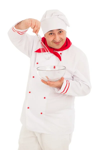 Smiling chef holding whisk and transparent bowl weraing red and — Stock Photo, Image