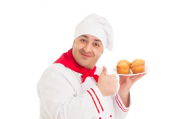 Σεφ, κρατώντας την πλάκα με 4 muffins, κόκκινο και λευκό στολή — Φωτογραφία Αρχείου