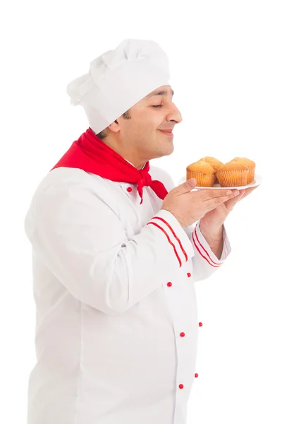 Chef holding plate with 4 muffins wearing red and white uniform — Stock Photo, Image