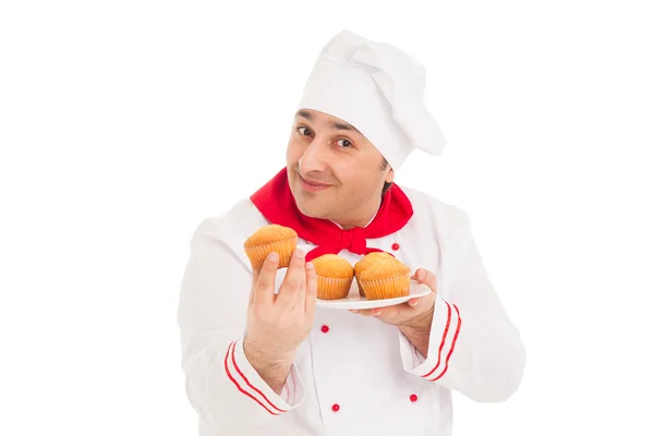 Chef holding plate with muffins wearing red and white uniform — Stock Photo, Image