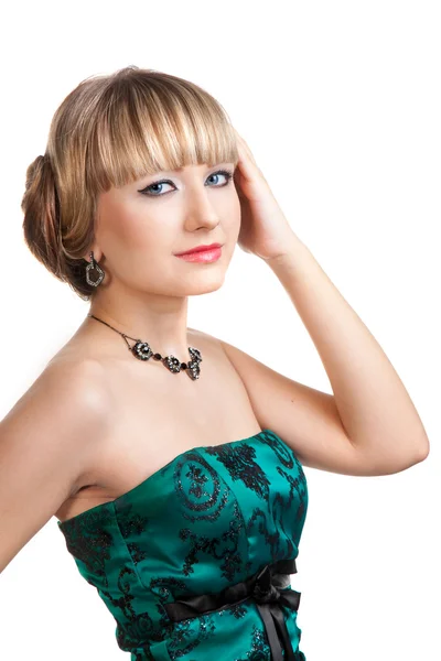 Beautiful girl in green evening dress with necklace and earrings — Stock Photo, Image