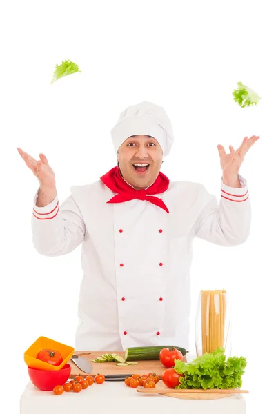 Happy chef holding leaf of salad and cooking with fresh vegetabl — Stock Photo, Image